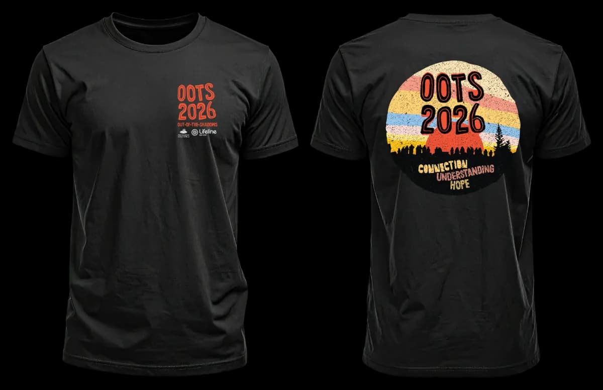The OOTS 2026 t-shirt, front and back: black, with a small chest print, and on the back a retro sunrise rising behind a crowd of walkers above the words Connection, Understanding, Hope.