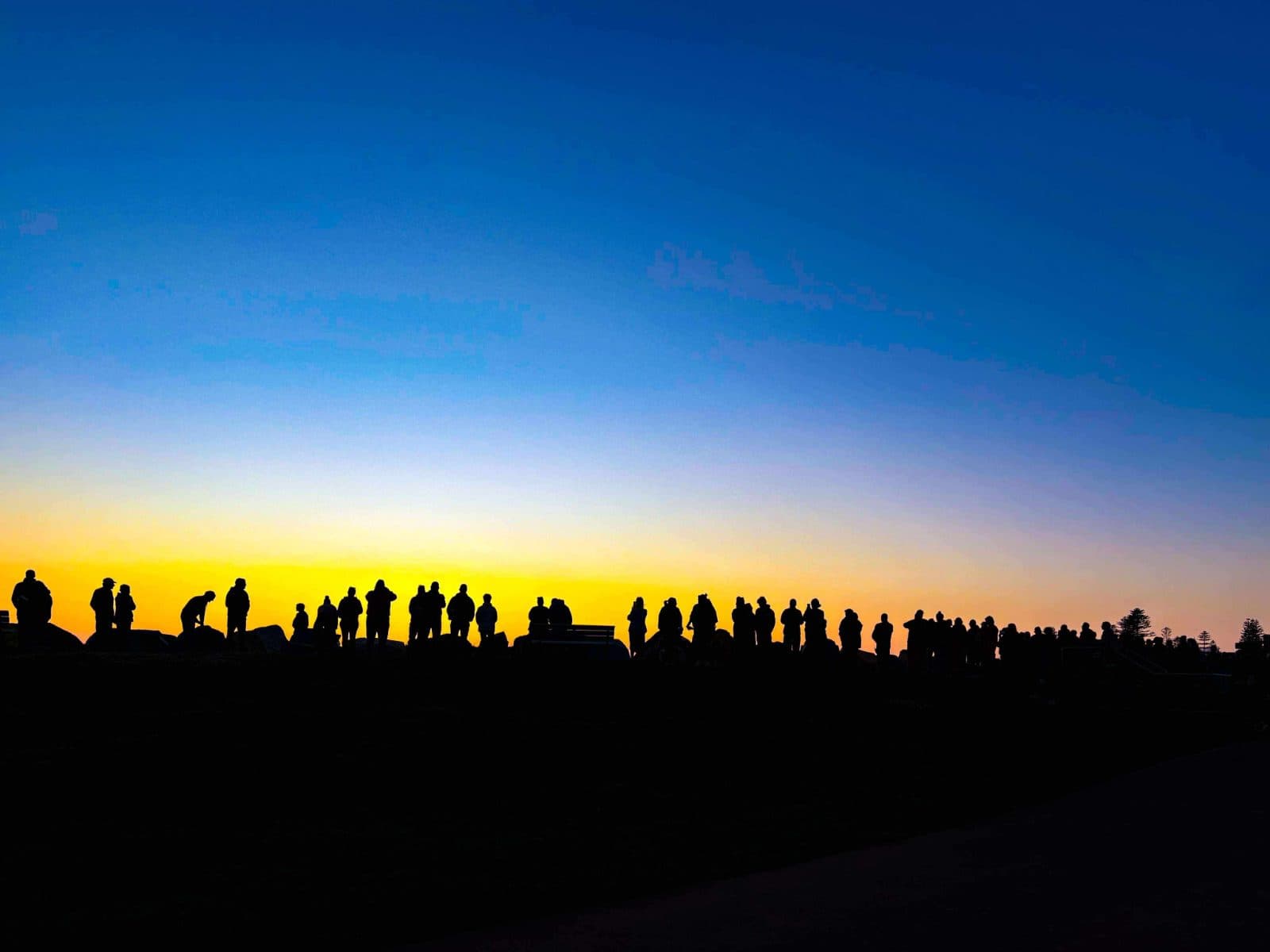 Community members gathered at dawn for the Out of the Shadows Walk